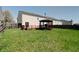 Lush backyard with a well-maintained lawn, wooden deck and gazebo at 10597 Cyrus Dr, Indianapolis, IN 46231
