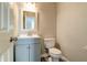 Cozy half bathroom featuring a vanity with sink and a toilet at 10597 Cyrus Dr, Indianapolis, IN 46231