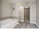 Cozy bathroom featuring a soaking tub and direct access to closet at 10597 Cyrus Dr, Indianapolis, IN 46231