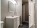 Modern bathroom with a white vanity, mirror, and an open doorway, offering a clean and functional design at 10597 Cyrus Dr, Indianapolis, IN 46231