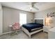 Inviting bedroom with a ceiling fan, desk, chair, large window, and closet for a functional and comfortable space at 10597 Cyrus Dr, Indianapolis, IN 46231