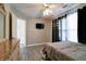 Bright bedroom featuring a ceiling fan, light walls, hardwood floors and dark curtains at 10597 Cyrus Dr, Indianapolis, IN 46231
