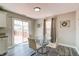 Eat-in kitchen area with a glass-top table, seating for four, and sliding glass doors at 10597 Cyrus Dr, Indianapolis, IN 46231