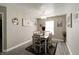 Charming dining room with a modern chandelier, decor, and a window at 10597 Cyrus Dr, Indianapolis, IN 46231