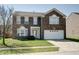 Two-story brick home with attached two-car garage and well-maintained lawn at 10597 Cyrus Dr, Indianapolis, IN 46231
