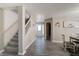 Spacious foyer with stairway featuring views into the dining room and the front door at 10597 Cyrus Dr, Indianapolis, IN 46231