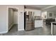 Modern kitchen includes stainless steel refrigerator, granite countertops and plenty of storage space at 10597 Cyrus Dr, Indianapolis, IN 46231