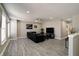 Spacious living room with a black sofa, television, and neutral walls at 10597 Cyrus Dr, Indianapolis, IN 46231