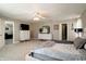 The spacious bedroom with plush carpets leads to the bathroom and the living spaces at 10597 Cyrus Dr, Indianapolis, IN 46231