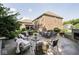 Backyard brick home with a patio featuring an outdoor seating area, manicured lawn, and garden beds at 1060 Cape Coral Dr, Cicero, IN 46034