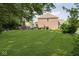 Expansive backyard with a brick outdoor fireplace perfect for entertaining, and lush green lawn at 1060 Cape Coral Dr, Cicero, IN 46034