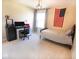 Cozy bedroom featuring a single bed, desk, and American flag wall decor at 1060 Cape Coral Dr, Cicero, IN 46034