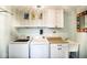 Functional laundry room featuring a washer, dryer, sink, countertop, and ample storage cabinets at 1060 Cape Coral Dr, Cicero, IN 46034