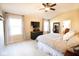 Bright bedroom featuring vaulted ceiling, two windows, neutral walls, ceiling fan, and television at 1060 Cape Coral Dr, Cicero, IN 46034