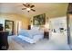 Spacious bedroom featuring neutral walls, large bed, ceiling fan, and attached office space at 1060 Cape Coral Dr, Cicero, IN 46034