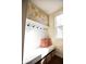 Inviting mudroom features a white bench with pillows and hooks, perfect for organization at 1060 Cape Coral Dr, Cicero, IN 46034