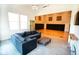 Comfortable living space adjacent to the basketball court featuring a cozy sofa and ample natural light at 1060 Cape Coral Dr, Cicero, IN 46034