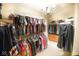 Large walk-in closet with organized clothing racks, shelves, and overhead lighting for ample storage at 1060 Cape Coral Dr, Cicero, IN 46034