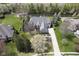 Stunning aerial view of estate with manicured landscaping, pond, and surrounding greenery at 10628 Walnut Creek W Dr, Carmel, IN 46032