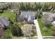 Beautiful aerial view of estate with manicured landscaping, pond, and surrounding greenery at 10628 Walnut Creek W Dr, Carmel, IN 46032