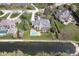 Aerial view showcasing the home's backyard pool, pond, and lush surrounding neighborhood at 10628 Walnut Creek W Dr, Carmel, IN 46032