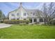 Well-maintained backyard with a patio, dining furniture, brick exterior, and lush green lawn at 10628 Walnut Creek W Dr, Carmel, IN 46032
