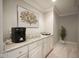 Stylish bar area featuring sleek countertops, modern appliances, and a refreshing indoor plant at 10628 Walnut Creek W Dr, Carmel, IN 46032