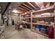 Unfinished basement with concrete floor and walls, open ceiling, and storage shelves at 10628 Walnut Creek W Dr, Carmel, IN 46032