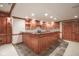 Finished basement with custom bar featuring rich wood cabinetry, granite counters, and stainless dishwasher at 10628 Walnut Creek W Dr, Carmel, IN 46032