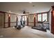 Finished basement with exercise equipment and natural light from the windows at 10628 Walnut Creek W Dr, Carmel, IN 46032