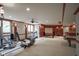 Spacious finished basement features an exercise area, game area, media space, and a custom bar at 10628 Walnut Creek W Dr, Carmel, IN 46032