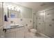 Well-lit bathroom with tiled shower, mosaic tile accents, and white vanity at 10628 Walnut Creek W Dr, Carmel, IN 46032