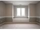 Bright bedroom features a window with built-in bench and carpeted floors at 10628 Walnut Creek W Dr, Carmel, IN 46032