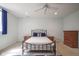 Bright bedroom featuring a queen-sized bed, ceiling fan, and matching nightstands at 10628 Walnut Creek W Dr, Carmel, IN 46032