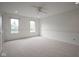 Bright bedroom featuring neutral carpet, fresh paint, and natural light from the double windows at 10628 Walnut Creek W Dr, Carmel, IN 46032