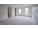 Bright bedroom featuring neutral carpet, fresh paint, closet, and natural light from the double windows at 10628 Walnut Creek W Dr, Carmel, IN 46032