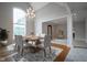 Elegant dining room with hardwood floors, chandelier, and large windows at 10628 Walnut Creek W Dr, Carmel, IN 46032