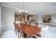 Open dining room features a wood table, chandelier, and an open floor plan with views to the kitchen and living room at 10628 Walnut Creek W Dr, Carmel, IN 46032