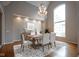 Lovely dining room featuring hardwood floors, chandelier and oversized windows at 10628 Walnut Creek W Dr, Carmel, IN 46032