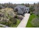 Stunning two-story brick home with a three-car garage, long driveway, and lush landscaping at 10628 Walnut Creek W Dr, Carmel, IN 46032