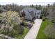 Stunning home with a long driveway, three car garage, mature landscaping, and a basketball hoop at 10628 Walnut Creek W Dr, Carmel, IN 46032
