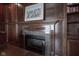 Close up of the wood paneled fireplace featuring marble surround, decorative mantel, and wood paneled walls at 10628 Walnut Creek W Dr, Carmel, IN 46032