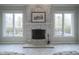 Bright and airy fireplace with natural lighting from the windows at 10628 Walnut Creek W Dr, Carmel, IN 46032