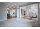 Elegant foyer featuring tile flooring, columns and entry to dining room and living room at 10628 Walnut Creek W Dr, Carmel, IN 46032