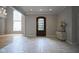 Elegant entryway with tiled floors, chandelier, and view to living spaces at 10628 Walnut Creek W Dr, Carmel, IN 46032