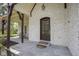 Beautiful front entry featuring covered porch with stone slate floor and timber pillars at 10628 Walnut Creek W Dr, Carmel, IN 46032
