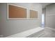 Clean hallway with neutral paint, white trim, and a functional storage bench at 10628 Walnut Creek W Dr, Carmel, IN 46032