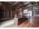 Traditional home office with wood paneled walls, coffered ceilings, fireplace, hardwood floors, and built-in shelving at 10628 Walnut Creek W Dr, Carmel, IN 46032