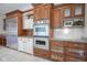 Kitchen featuring stainless steel double ovens and refrigerator with custom cabinetry at 10628 Walnut Creek W Dr, Carmel, IN 46032