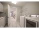 Convenient laundry room featuring modern appliances, ample counter space, and direct access to the staircase at 10628 Walnut Creek W Dr, Carmel, IN 46032